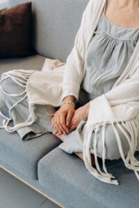 Hands resting on a soft cream throw