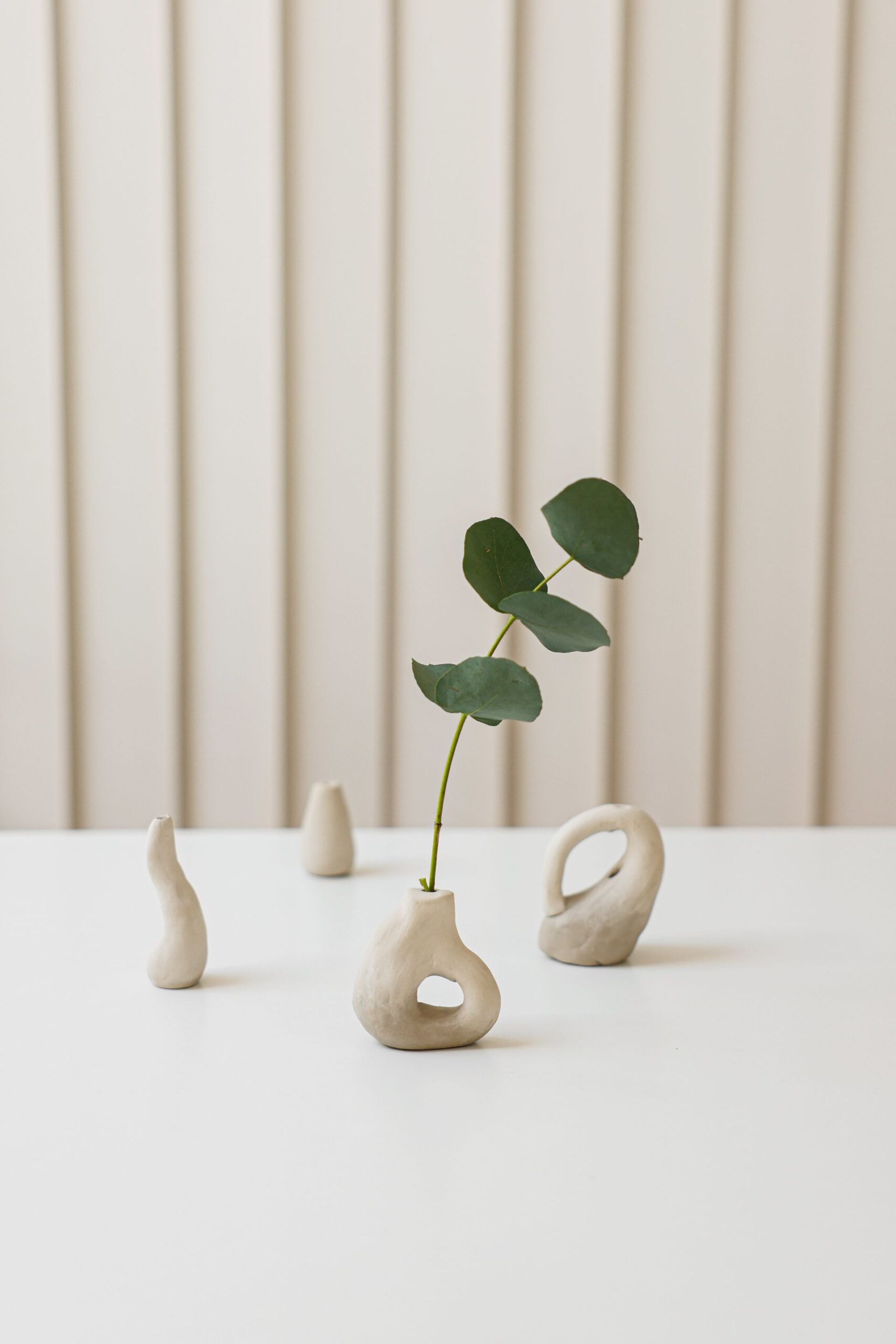A single leaf in a small handmade vase